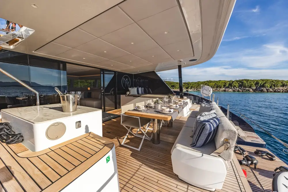 Aft deck lounge and dining table at anchor