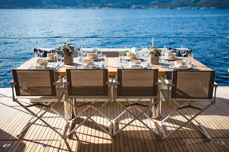 Lunch set for eight on the aft deck of a crewed catamaran