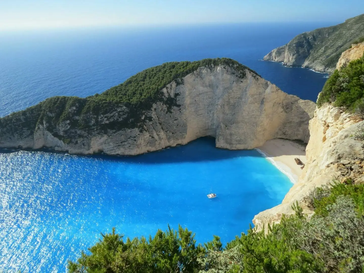 A yacht anchored in a sheltered Ionian bay