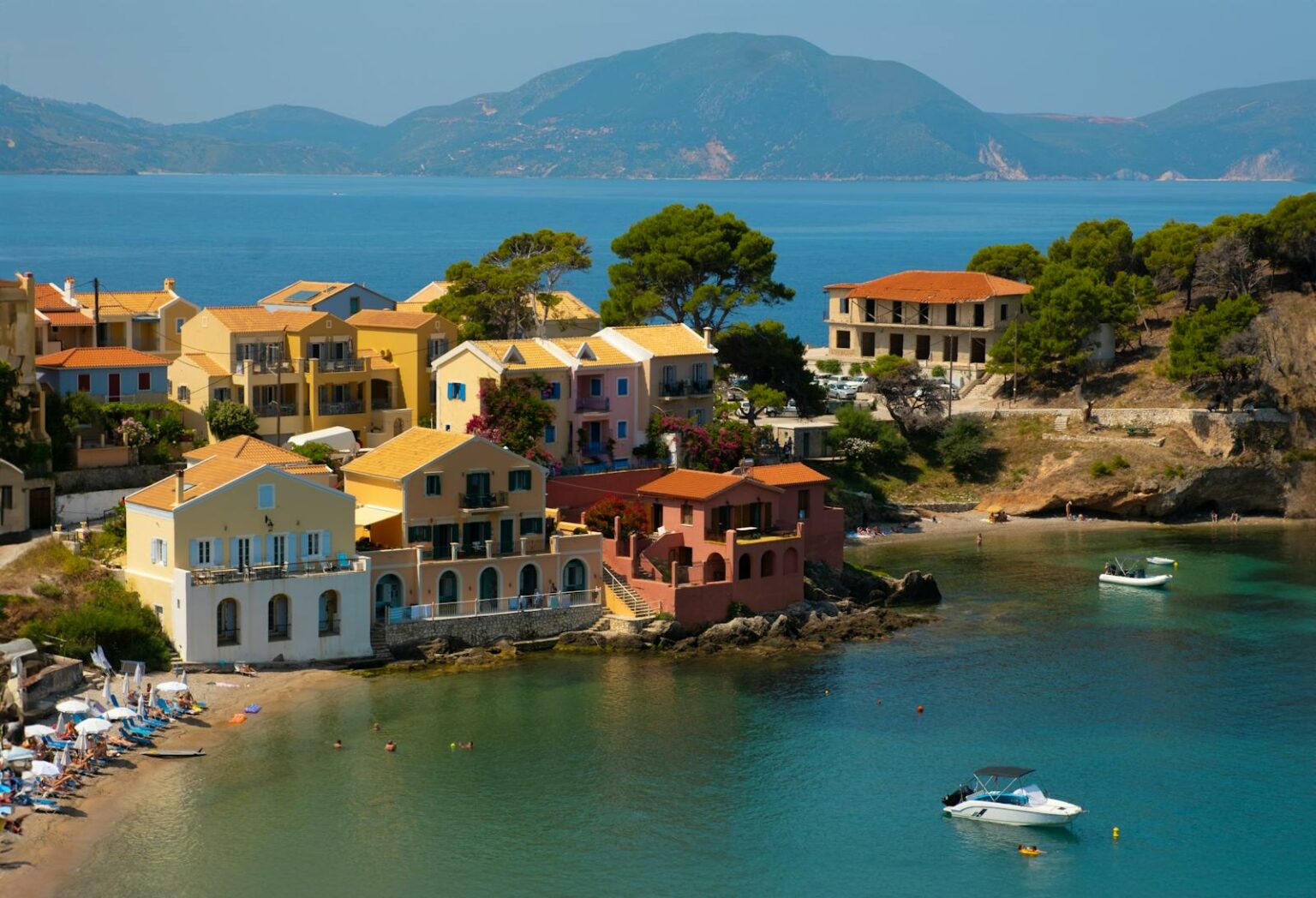 Idyllic coastal village in Kefalos, Greece with colorful houses by the sea.