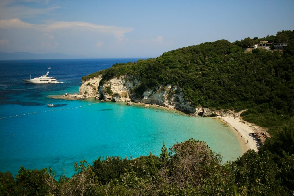 Beautiful beach with turquoise water and a yacht.